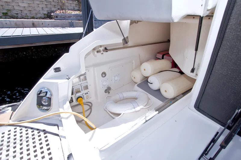 Slide: The Image of 2021 Sea Ray SLX 400 Outboard storage area with fenders and life ring. - 71