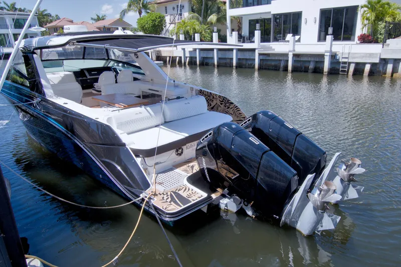Slide: The Image of 2021 Sea Ray SLX 400 Outboard luxury boat docked in a serene waterfront setting. - 72
