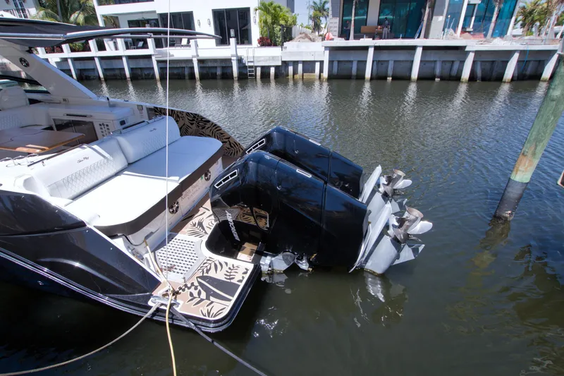 Slide: The Image of 2021 Sea Ray SLX 400 Outboard boat docked, showcasing luxurious seating and powerful engines. - 73