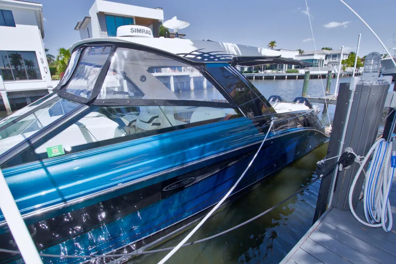 Slide: The Image of 2021 Sea Ray SLX 400 Outboard docked near modern waterfront homes. - 76