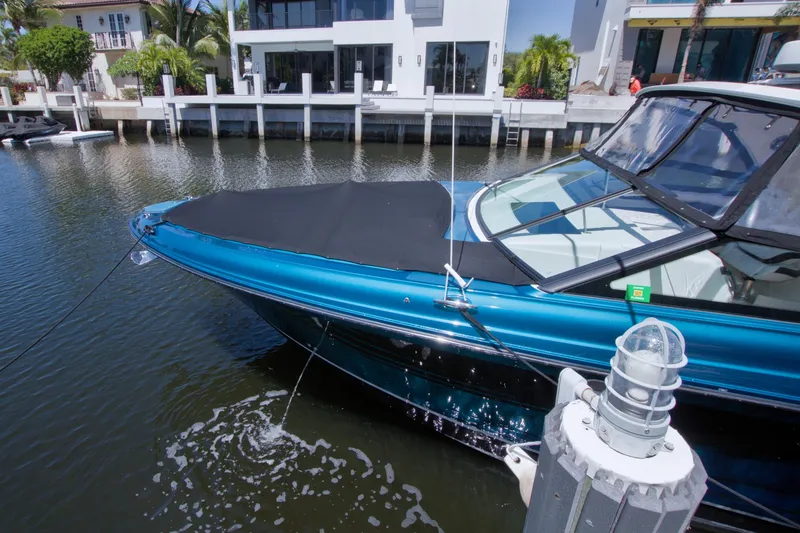 Slide: The Image of 2021 Sea Ray SLX 400 Outboard docked by waterfront homes. - 77