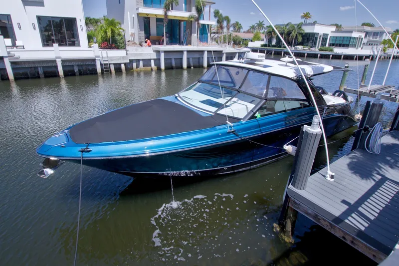 Slide: The Image of 2021 Sea Ray SLX 400 Outboard docked in a sunny waterfront setting. - 78