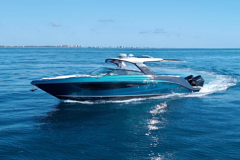 Slide: The Image of 2021 Sea Ray SLX 400 Outboard cruising on open water under clear blue skies. - 79