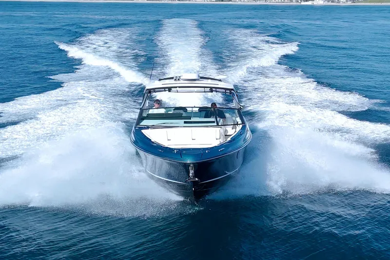 Slide: The Image of 2021 Sea Ray SLX 400 Outboard cruising on open water, creating a dynamic wake. - 8