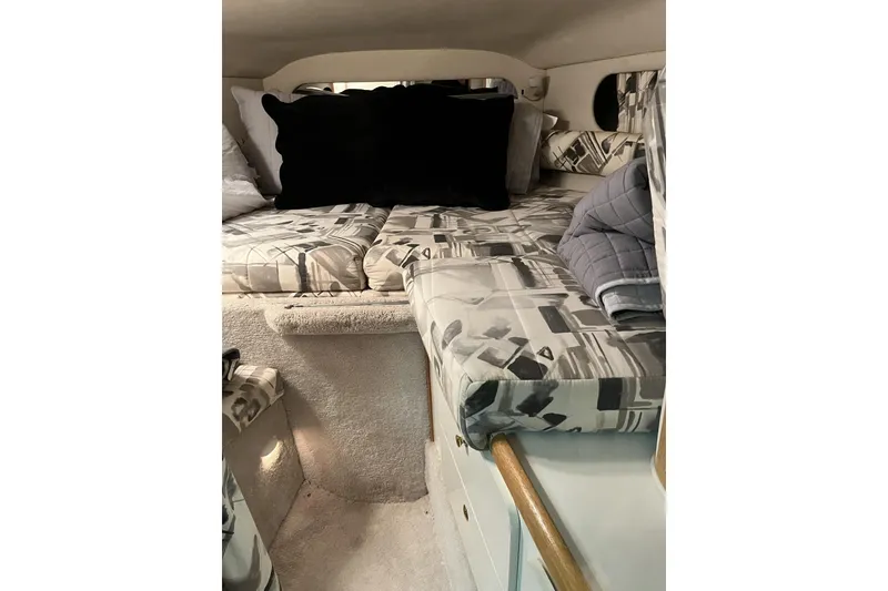 Slide: The Image of Interior cabin of 1997 Sea Ray 290 Sundancer with patterned cushions and pillows. - 10