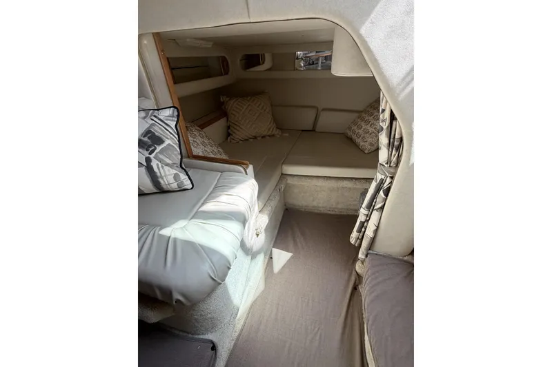 Slide: The Image of Interior cabin of 1997 Sea Ray 290 Sundancer with cozy seating and cushions. - 11