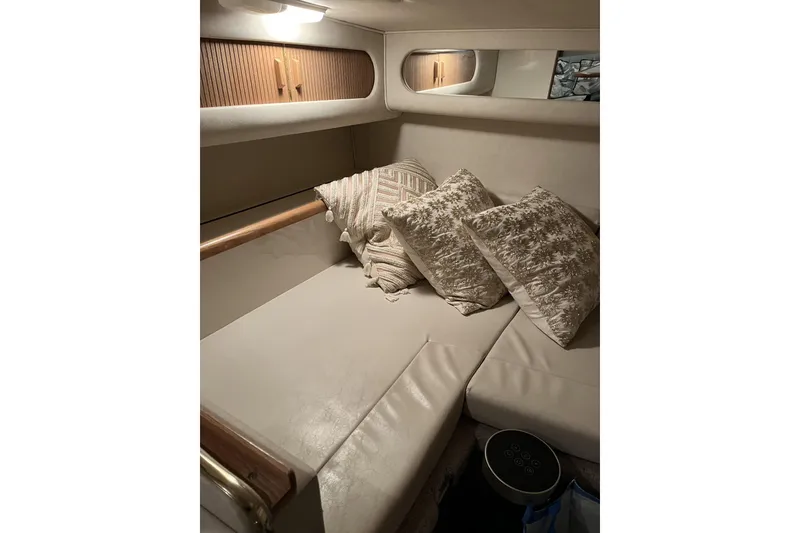 Slide: The Image of Cozy cabin interior of 1997 Sea Ray 290 Sundancer with cushions and soft lighting. - 12