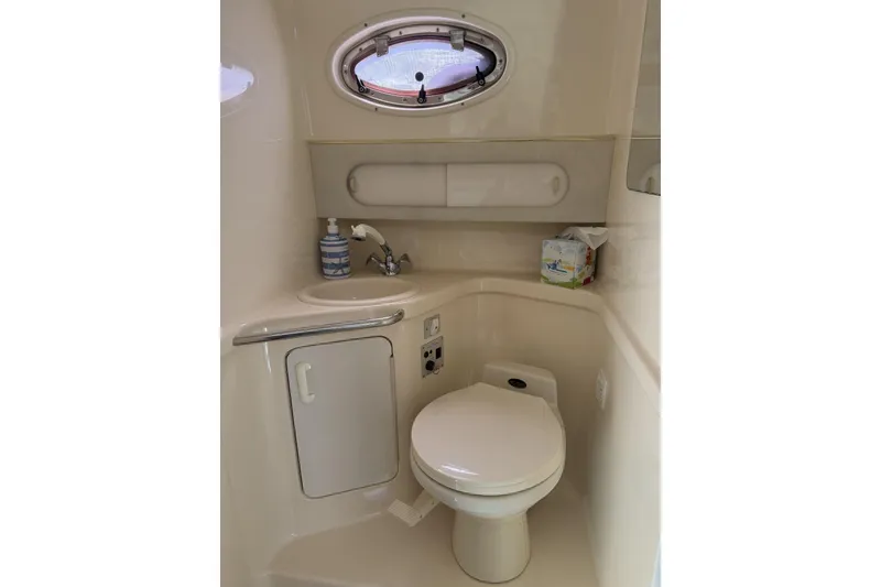 Slide: The Image of Bathroom interior of 1997 Sea Ray 290 Sundancer boat, featuring sink and toilet. - 20
