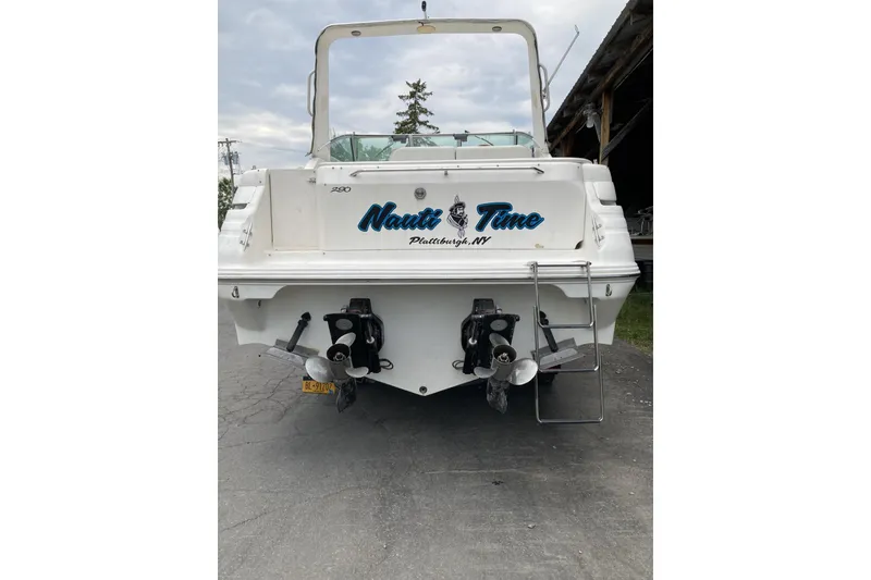 Slide: The Image of 1997 Sea Ray 290 Sundancer boat rear view with "Nauti Time" text, Plattsburgh, NY. - 3