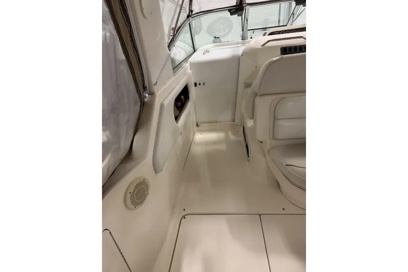 Slide: The Image of 1997 Sea Ray 290 Sundancer boat interior with white seating and dashboard. - 8