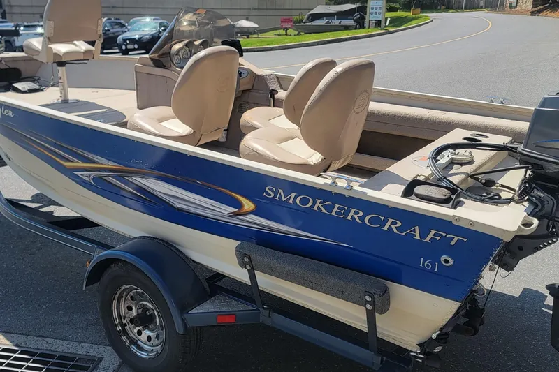Slide: The Image of 2009 Smoker Craft Pro Angler 161 boat on trailer, featuring blue and beige design. - 3