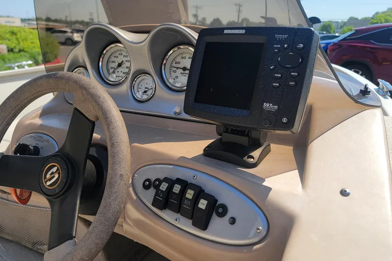 Slide: The Image of 2009 Smoker Craft Pro Angler 161 dashboard with steering wheel and fishfinder display. - 5