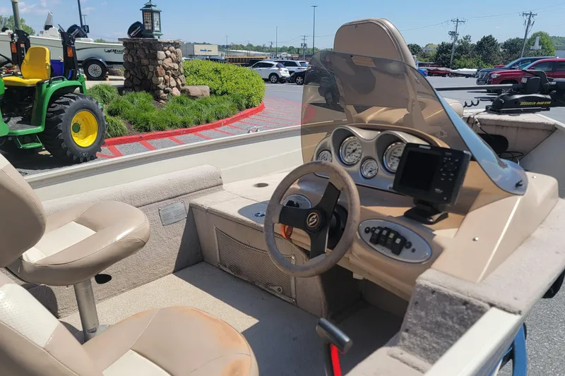 Slide: The Image of 2009 Smoker Craft Pro Angler 161 boat interior with steering wheel and dashboard controls. - 7