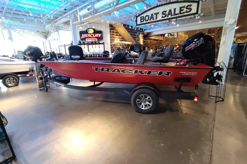The Image of 2026 Tracker Pro Team 195 boat displayed in showroom with Mercury engine. - 0