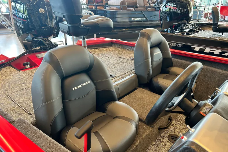 Slide: The Image of 2026 Tracker Pro Team 175 boat interior with black seats and steering wheel. - 3