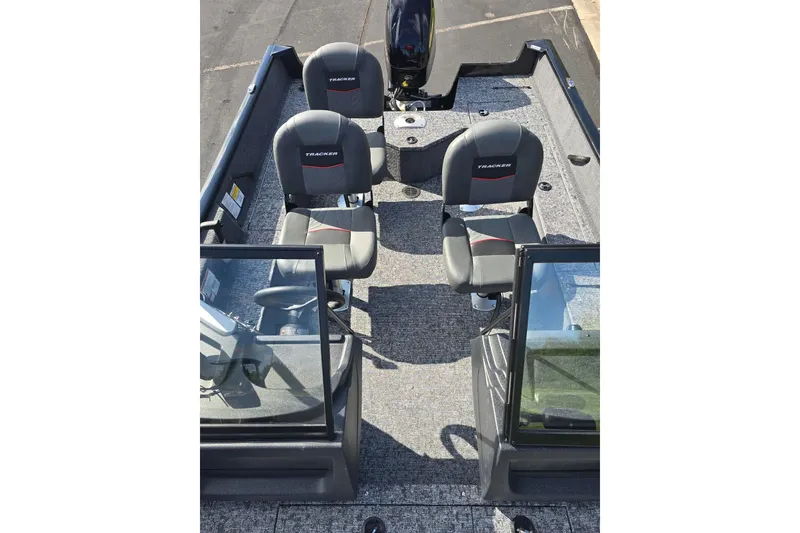 Slide: The Image of 2026 Tracker Pro Guide V-16 WT boat interior with seating and windshield. - 2