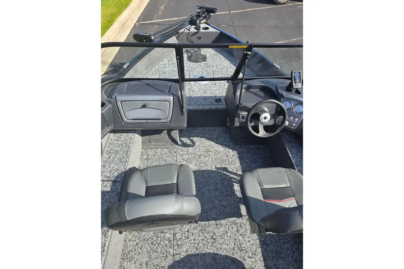 Slide: The Image of 2026 Tracker Pro Guide V-16 WT boat interior with steering wheel and seating. - 3