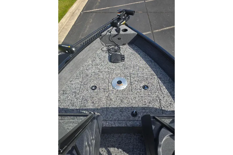 Slide: The Image of 2026 Tracker Pro Guide V-16 WT boat deck with trolling motor and carpeted surface. - 5