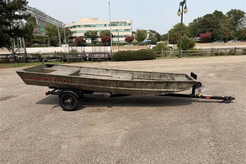 Slide: The Image of 2026 Tracker Grizzly 15 Jon boat on trailer in parking lot. - 5