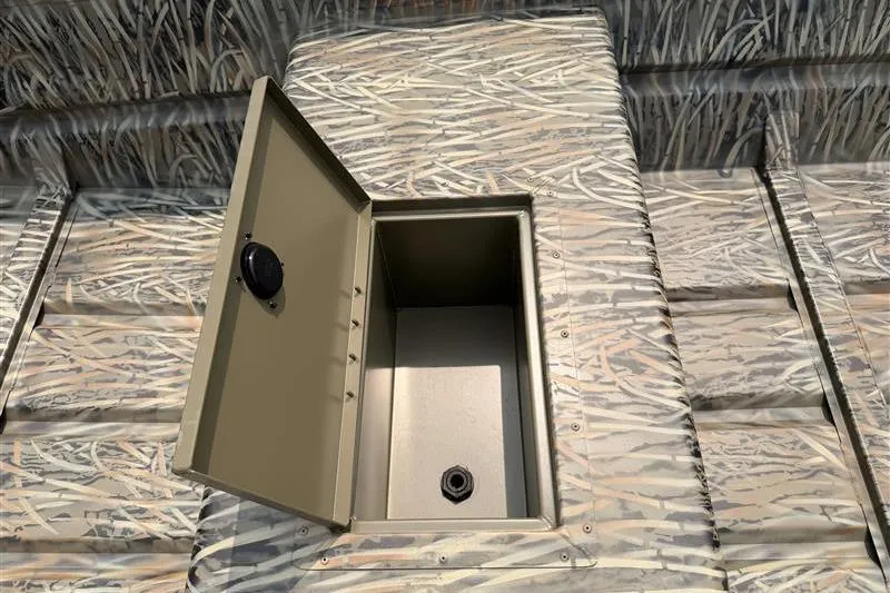 Slide: The Image of 2026 Tracker Grizzly 15 Jon boat with open storage compartment, camo pattern. - 8