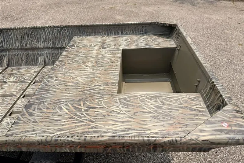 Slide: The Image of 2026 Tracker Grizzly 15 Jon boat with camouflage pattern and storage compartment. - 9