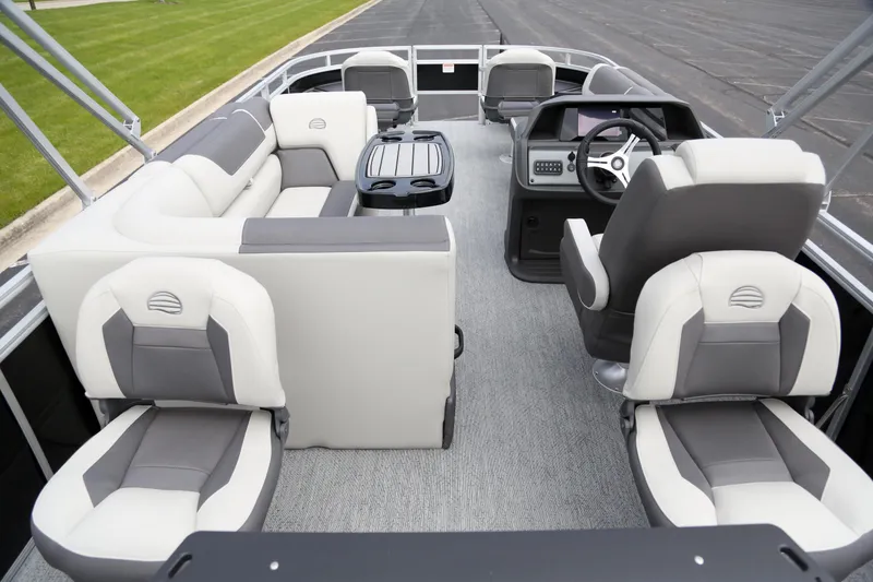 Slide: The Image of 2026 Sun Tracker Fishin' Barge 20 DLX interior with plush seating and modern dashboard. - 4