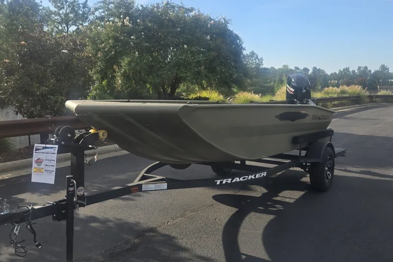 Slide: The Image of 2026 Tracker Grizzly 1650 T Prairie Wings Edition boat on trailer, parked outdoors. - 34
