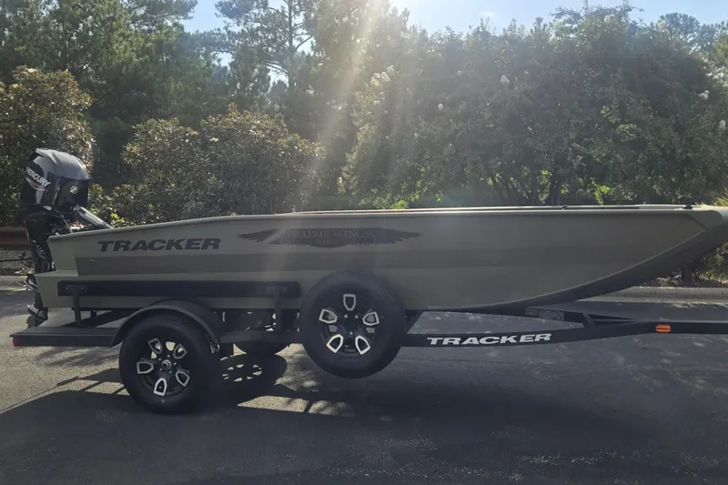 The Image of 2026 Tracker Grizzly 1650 T Prairie Wings Edition boat on trailer, outdoors. - 0