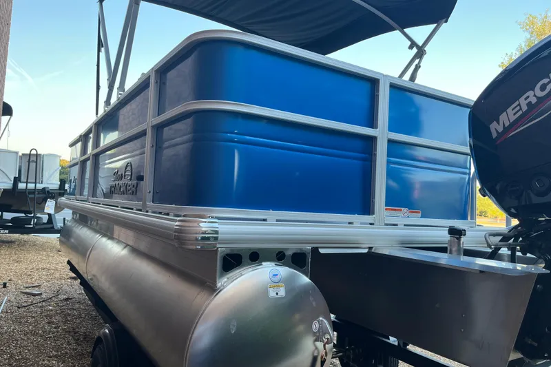 Slide: The Image of 2026 Sun Tracker Party Barge 18 DLX pontoon boat with blue panels and Mercury engine. - 3
