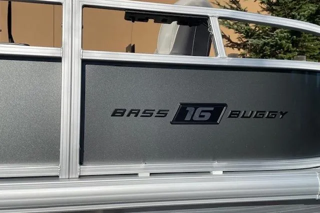 Slide: The Image of 2026 Sun Tracker Bass Buggy 16 XL Select pontoon boat side view. - 3