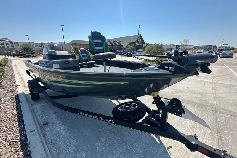Slide: The Image of 2026 Ranger VS1782SC Angler boat on trailer in parking lot, featuring Minn Kota trolling motor. - 7