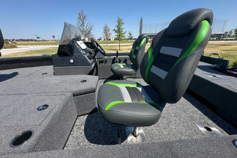 Slide: The Image of 2026 Ranger VS1782SC Angler boat interior with gray and green seating, dashboard, and carpeted flooring. - 13