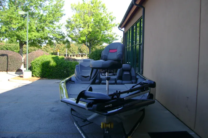 Slide: The Image of 2026 Tracker Pro Team 190 boat parked outdoors near a building. - 3
