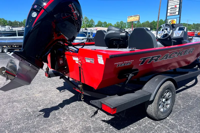 Slide: The Image of Red 2026 Tracker Pro Team 195 boat with powerful outboard motor on trailer. - 2