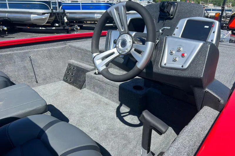 Slide: The Image of Interior of 2026 Tracker Pro Team 195 boat with steering wheel and control panel. - 6