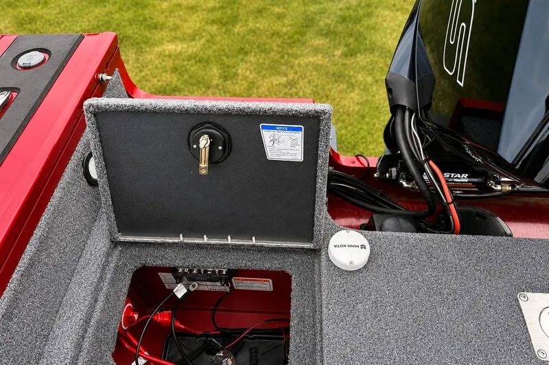 Slide: The Image of 2026 Tracker Targa V-19 Combo boat battery compartment with open hatch and wiring. - 15