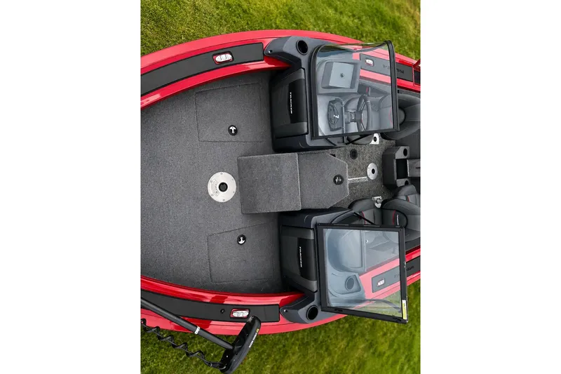 Slide: The Image of 2026 Tracker Targa V-19 Combo boat interior with dual windshields and seating on grass. - 16