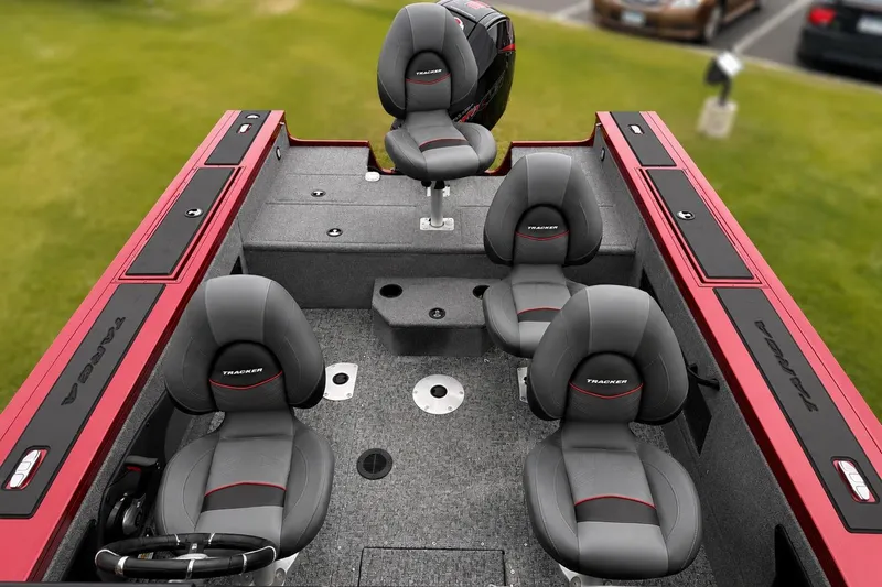 Slide: The Image of 2026 Tracker Targa V-19 Combo boat interior with gray seats and red accents. - 12