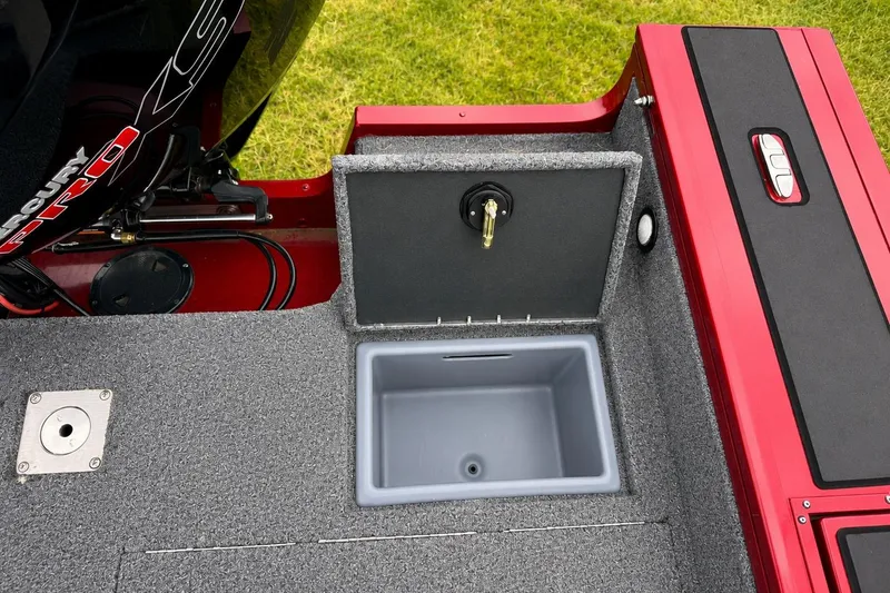 Slide: The Image of 2026 Tracker Targa V-19 Combo boat interior with storage compartment and engine detail. - 13