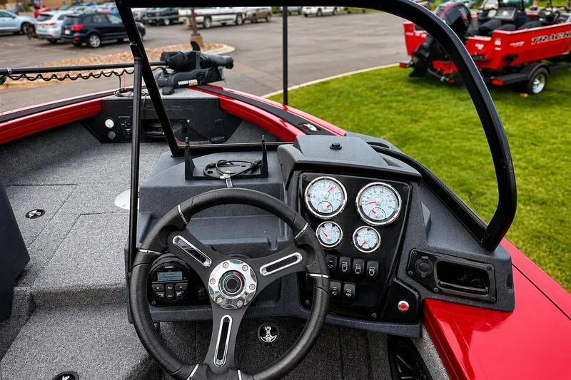 Slide: The Image of 2026 Tracker Targa V-19 Combo boat dashboard with steering wheel and gauges. - 7