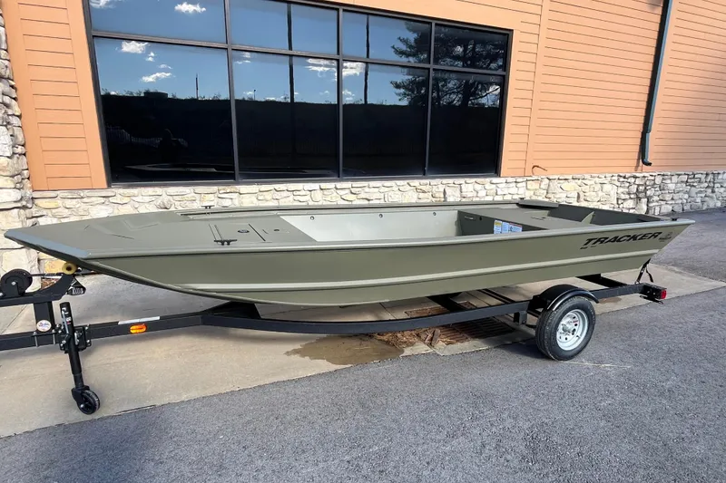 The Image of 2026 Tracker Grizzly 1648 Utility boat on trailer outside building. - 0