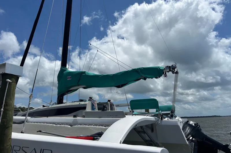 Slide: The Image of 2023 Corsair 880 sailboat docked under a cloudy sky. - 12