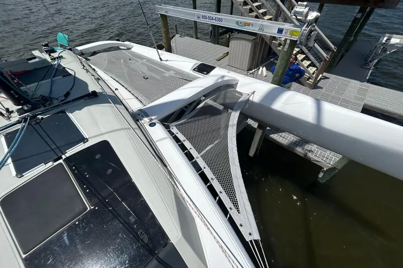 Slide: The Image of 2023 Corsair 880 sailboat docked, showcasing deck and rigging details. - 19