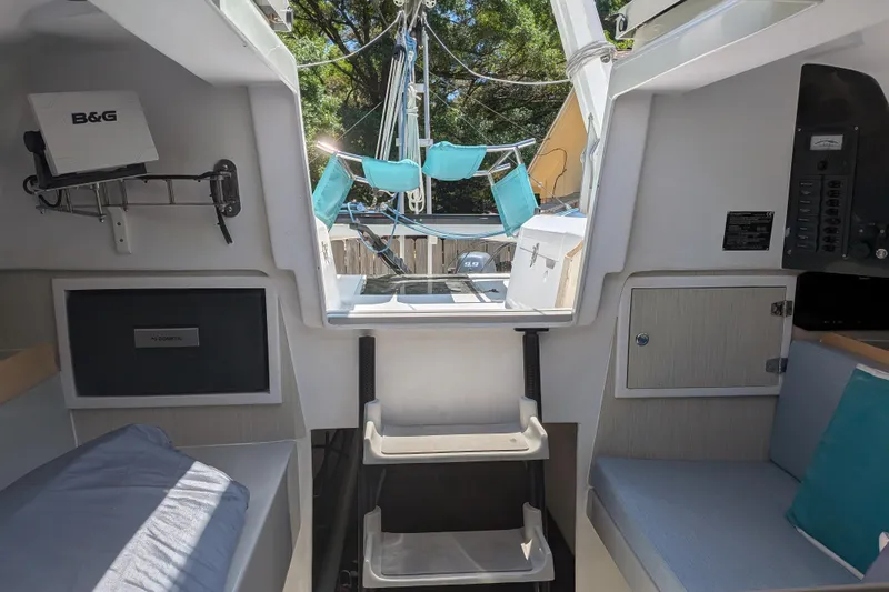 Slide: The Image of Interior of 2023 Corsair 880 sailboat, featuring modern equipment and comfortable seating. - 23