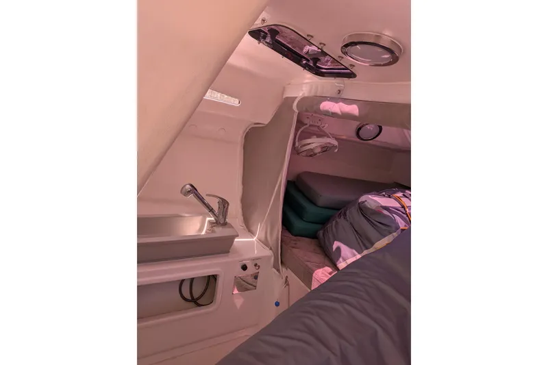 Slide: The Image of Interior of 2023 Corsair 880 sailboat cabin with sink and sleeping area. - 24