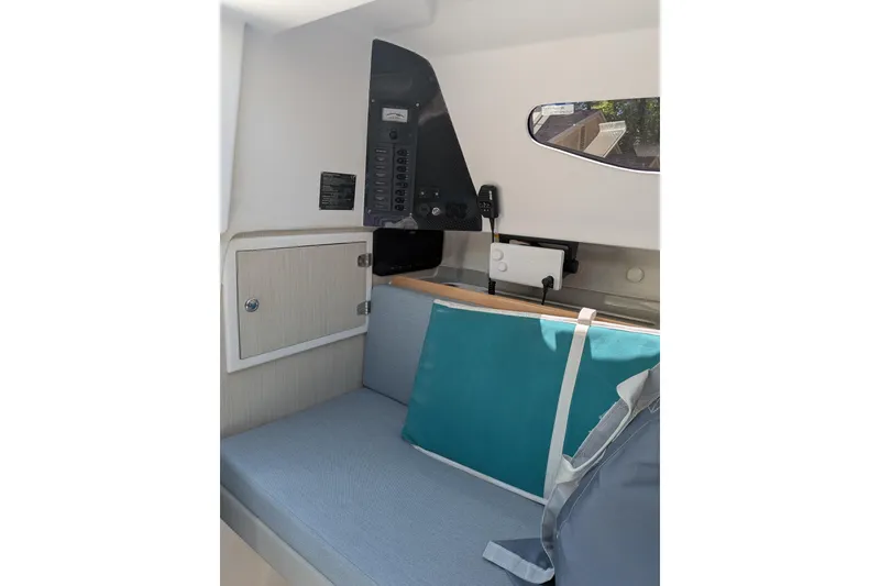 Slide: The Image of Interior of 2023 Corsair 880 sailboat with seating, control panel, and storage. - 27