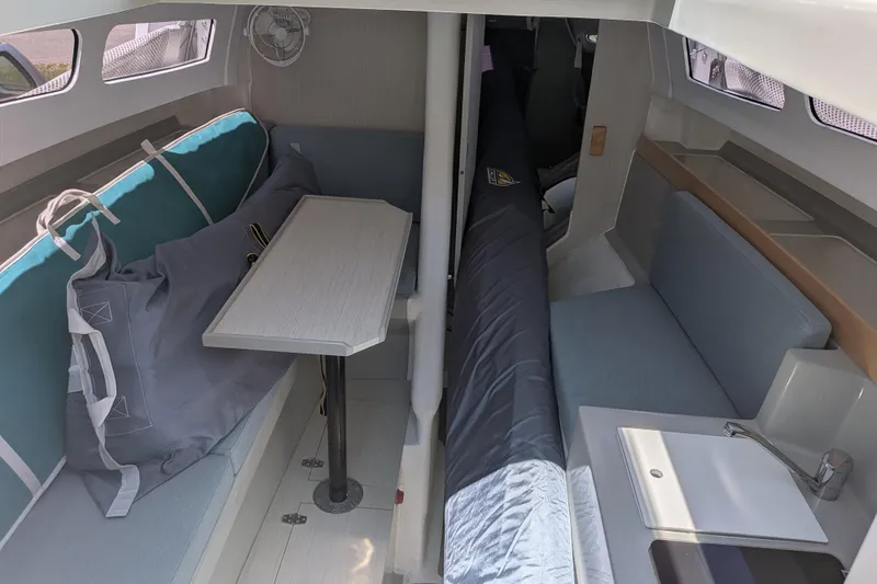 Slide: The Image of Interior of 2023 Corsair 880 sailboat with seating, table, and sink. - 28