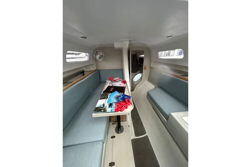 Slide: The Image of Interior of 2023 Corsair 880 sailboat with seating and table, showcasing modern design. - 31