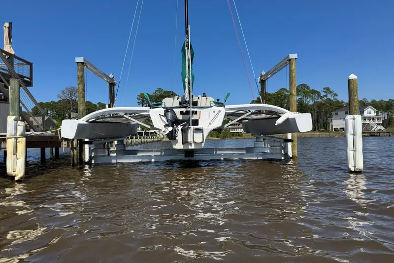 Slide: The Image of 2023 Corsair 880 trimaran sailboat docked on a sunny day, showcasing sleek design and modern features. - 5