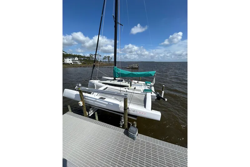 Slide: The Image of Sailboat Corsair 880, 2023 model, docked on a sunny day by the water. - 6